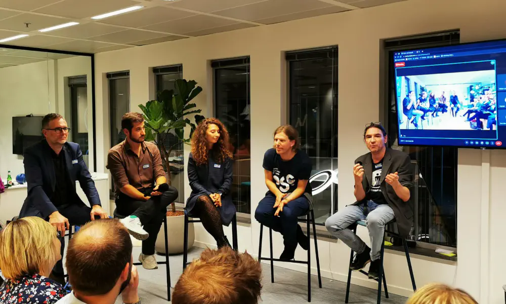 A picture showing the event 'Breaking the Silos: Hybrid & Remote Work in Tech' taking place.